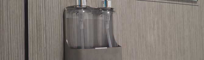 What products should I use to clean my stainless steel washroom dispensers?