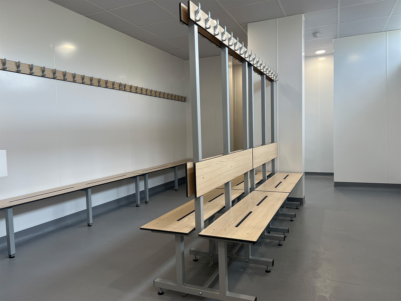 Changing room island benches with matching coat hooks